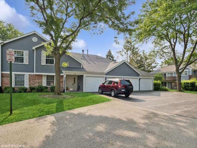 751 Sterling Ct Unit D1, Bartlett, IL 60103 - view of front of house featuring brick siding, a front lawn, a garage, and concrete driveway