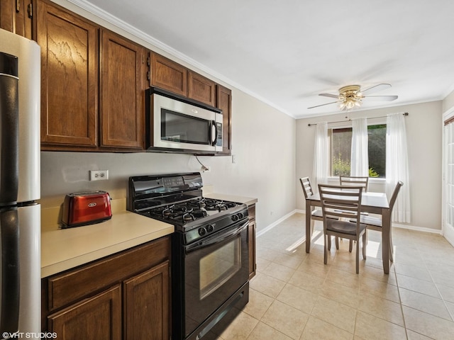 751 Sterling Ct Unit D1, Bartlett, IL 60103 - kitchen featuring appliances with stainless steel finishes, crown molding, light countertops, ceiling fan, and light tile patterned floors