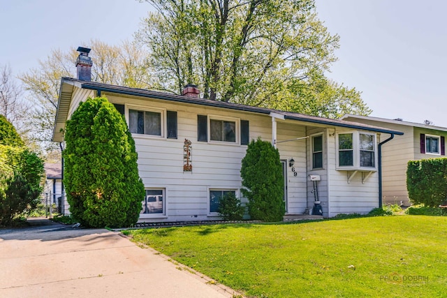 69 N Greenview Ave, Mundelein, IL 60060 - raised ranch featuring a chimney and a front lawn