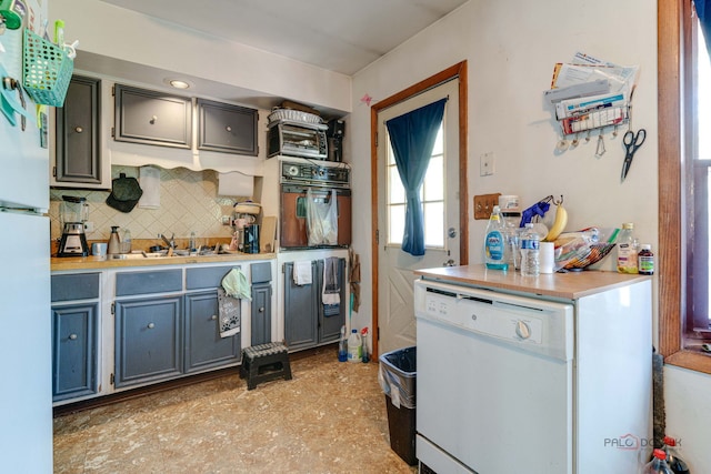 69 N Greenview Ave, Mundelein, IL 60060 - kitchen featuring black oven, a sink, decorative backsplash, light countertops, and freestanding refrigerator