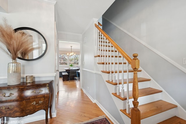 816 S Hamlin Ave, Park Ridge, IL 60068 - stairway with ornamental molding, wood finished floors, a chandelier, and baseboards