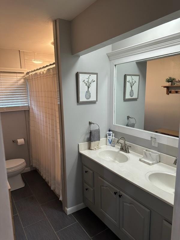 1415 Woodridge Dr, Danville, IL 61832 - bathroom with double vanity, toilet, and a shower with shower curtain
