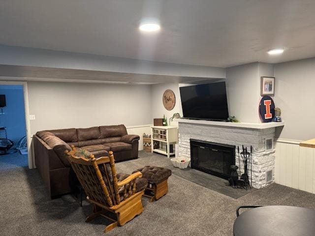 1415 Woodridge Dr, Danville, IL 61832 - living room featuring carpet, a wainscoted wall, and a stone fireplace