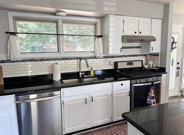 1415 Woodridge Dr, Danville, IL 61832 - kitchen featuring stainless steel appliances, under cabinet range hood, a sink, dark countertops, and white cabinets