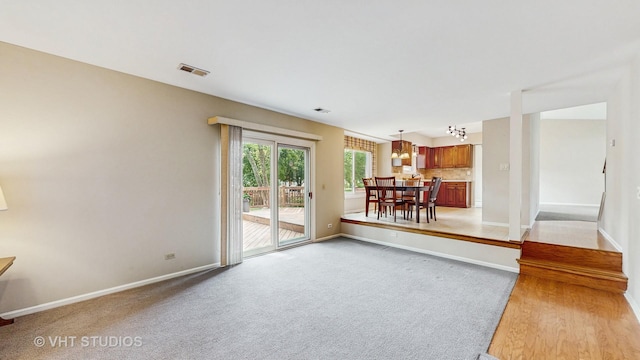 500 Shallow Cove Rd, Lake Zurich, IL 60047 - unfurnished living room featuring baseboards, light carpet, and a chandelier