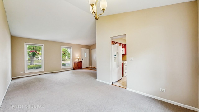 500 Shallow Cove Rd, Lake Zurich, IL 60047 - unfurnished living room featuring light carpet, baseboards, lofted ceiling, and a chandelier