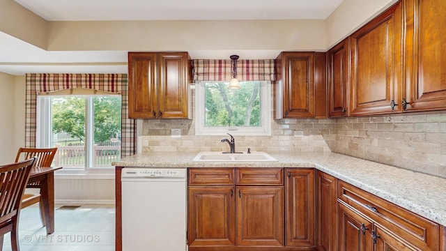 500 Shallow Cove Rd, Lake Zurich, IL 60047 - kitchen featuring white dishwasher, a sink, brown cabinetry, tasteful backsplash, and baseboards