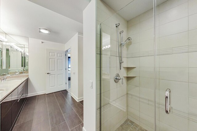 225 N Columbus Dr Unit 6305, Chicago, IL 60601 - full bathroom featuring a stall shower, double vanity, and baseboards