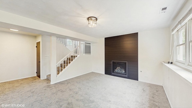 2525 Ridge Rd, Aurora, IL 60504 - unfurnished living room featuring carpet flooring, stairs, a large fireplace, and baseboards