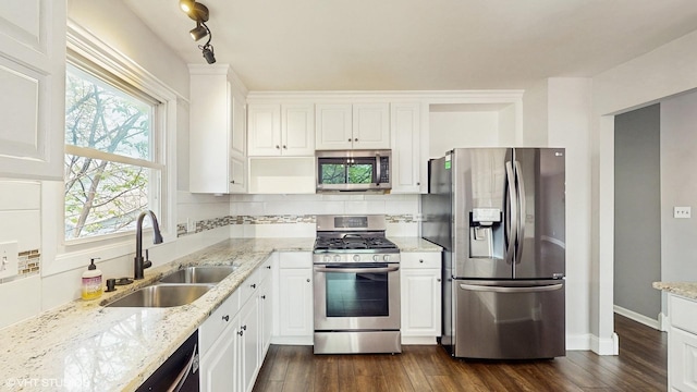 2525 Ridge Rd, Aurora, IL 60504 - kitchen with appliances with stainless steel finishes, a sink, dark wood-style floors, white cabinets, and light stone countertops