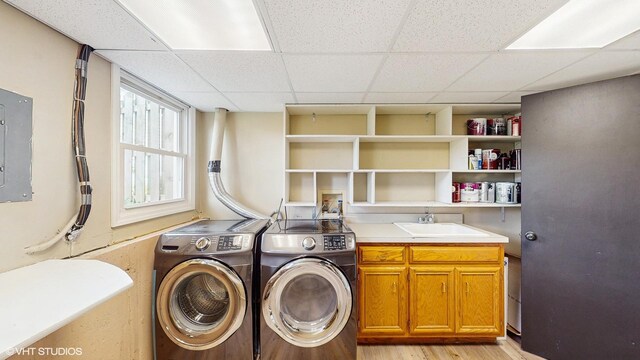 2525 Ridge Rd, Aurora, IL 60504 - laundry area featuring washing machine and clothes dryer, cabinet space, electric panel, and light wood-style floors