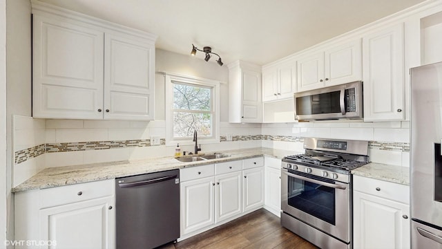 2525 Ridge Rd, Aurora, IL 60504 - kitchen featuring stainless steel appliances, a sink, white cabinets, dark wood finished floors, and backsplash