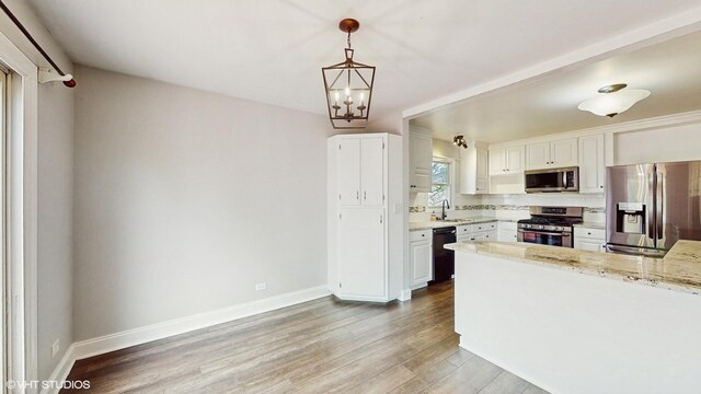 2525 Ridge Rd, Aurora, IL 60504 - kitchen with stainless steel appliances, a sink, light wood finished floors, and baseboards