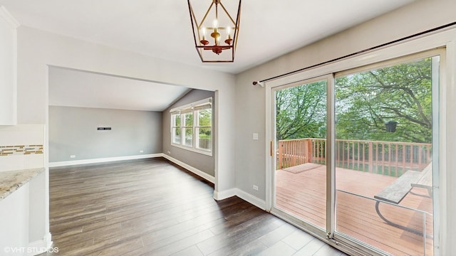 2525 Ridge Rd, Aurora, IL 60504 - doorway to outside with lofted ceiling, baseboards, wood finished floors, and a chandelier