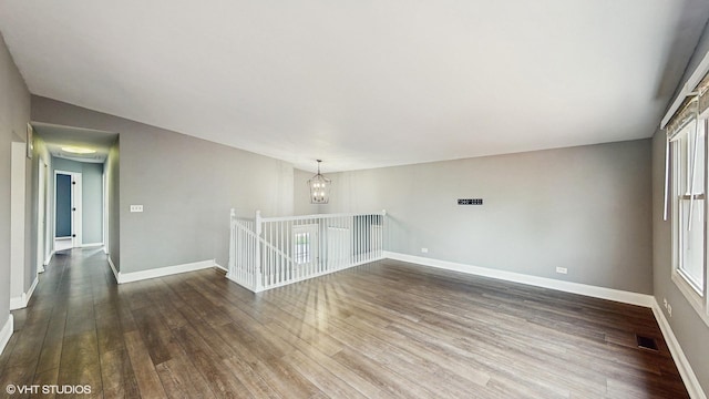 2525 Ridge Rd, Aurora, IL 60504 - spare room with dark wood-type flooring, a chandelier, plenty of natural light, and baseboards