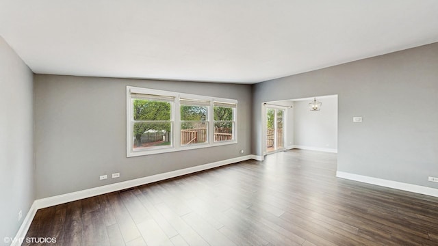 2525 Ridge Rd, Aurora, IL 60504 - spare room featuring a chandelier, baseboards, and dark wood finished floors