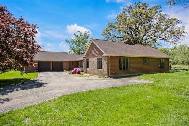 3262 Greenwood Dr, Dewey, IL 61840 - view of front of house featuring a garage, driveway, a front yard, and roof with shingles