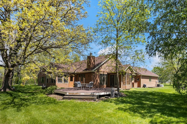 3262 Greenwood Dr, Dewey, IL 61840 - back of property featuring a sunroom, a deck, a yard, a chimney, and central air condition unit