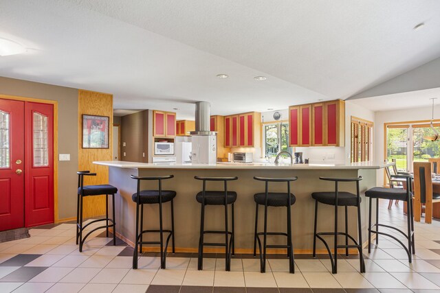 3262 Greenwood Dr, Dewey, IL 61840 - kitchen with island exhaust hood, white microwave, light countertops, a peninsula, and a sink