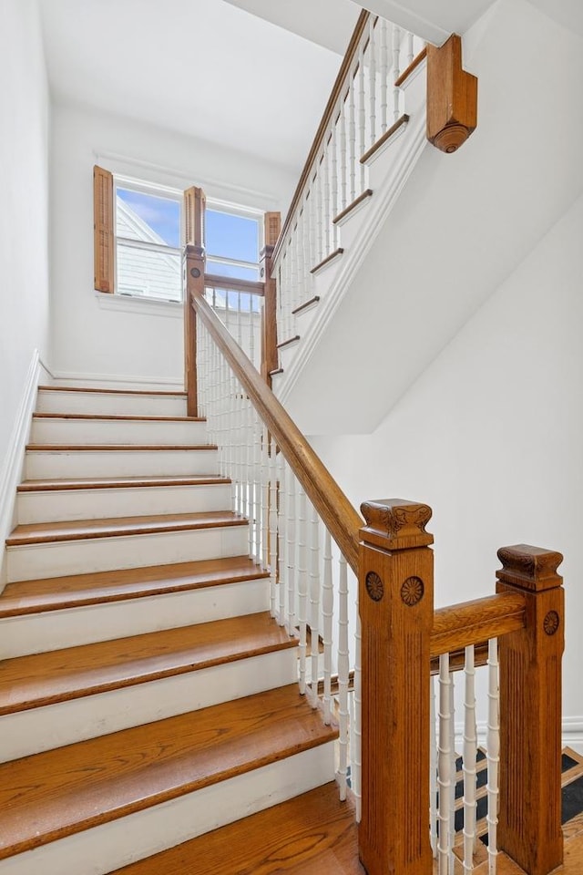 stairs with baseboards and wood finished floors