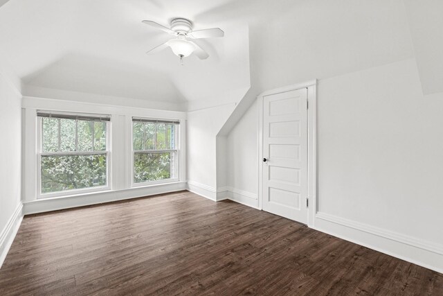 additional living space featuring wood finished floors, lofted ceiling, ceiling fan, and baseboards