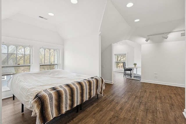 bedroom featuring vaulted ceiling, wood finished floors, track lighting, baseboards, and recessed lighting