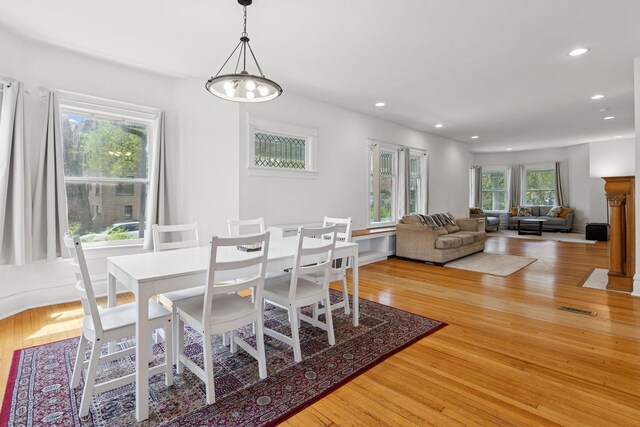 dining space with light wood-style floors and recessed lighting