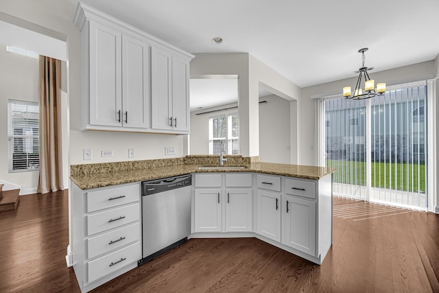 kitchen featuring dishwasher, dark wood finished floors, a sink, a chandelier, and light stone countertops