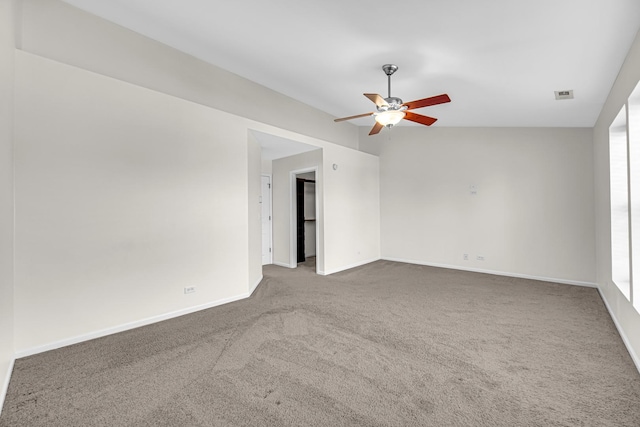 empty room with ceiling fan, carpet, and baseboards