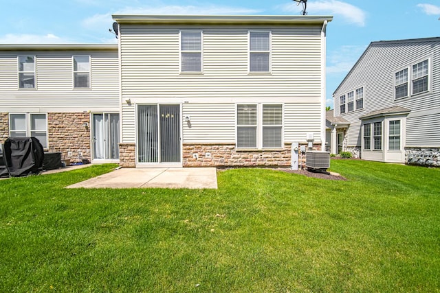rear view of property featuring stone siding, a lawn, and central air condition unit