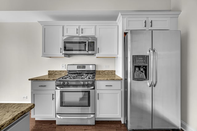 kitchen with stainless steel appliances, stone countertops, dark wood-type flooring, and white cabinetry