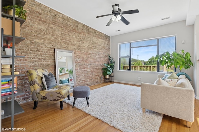 4817 N Fairfield Ave Unit 3, Chicago, IL 60625 - living room with a ceiling fan, wood finished floors, baseboards, and brick wall
