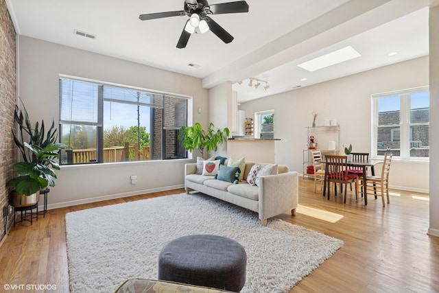 4817 N Fairfield Ave Unit 3, Chicago, IL 60625 - living area featuring light wood-style floors, a skylight, baseboards, and ceiling fan