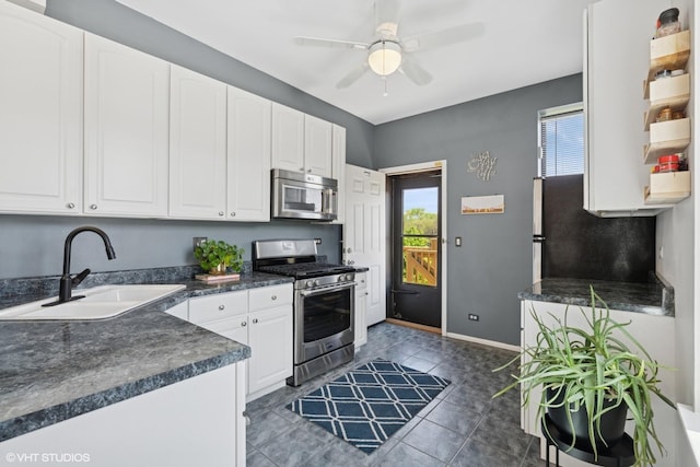 4817 N Fairfield Ave Unit 3, Chicago, IL 60625 - kitchen featuring stainless steel appliances, a sink, dark countertops, open shelves, and white cabinetry