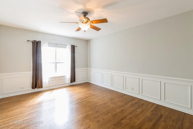 921 Eineke Blvd, Algonquin, IL 60102 - unfurnished room with ceiling fan, a wainscoted wall, wood finished floors, and a decorative wall
