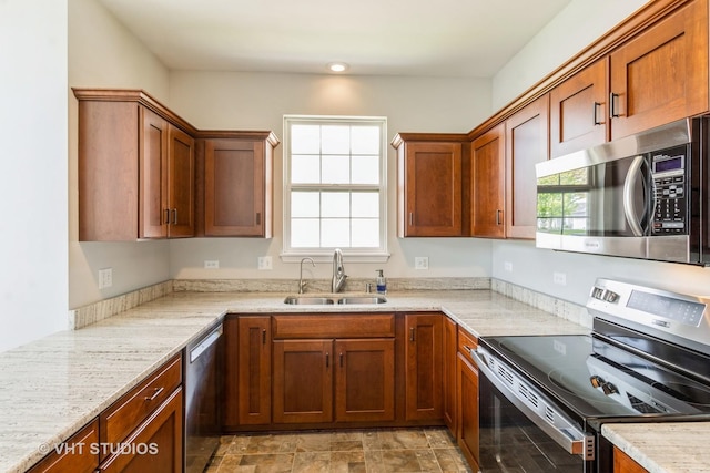 921 Eineke Blvd, Algonquin, IL 60102 - kitchen with appliances with stainless steel finishes, a sink, healthy amount of natural light, and light stone countertops