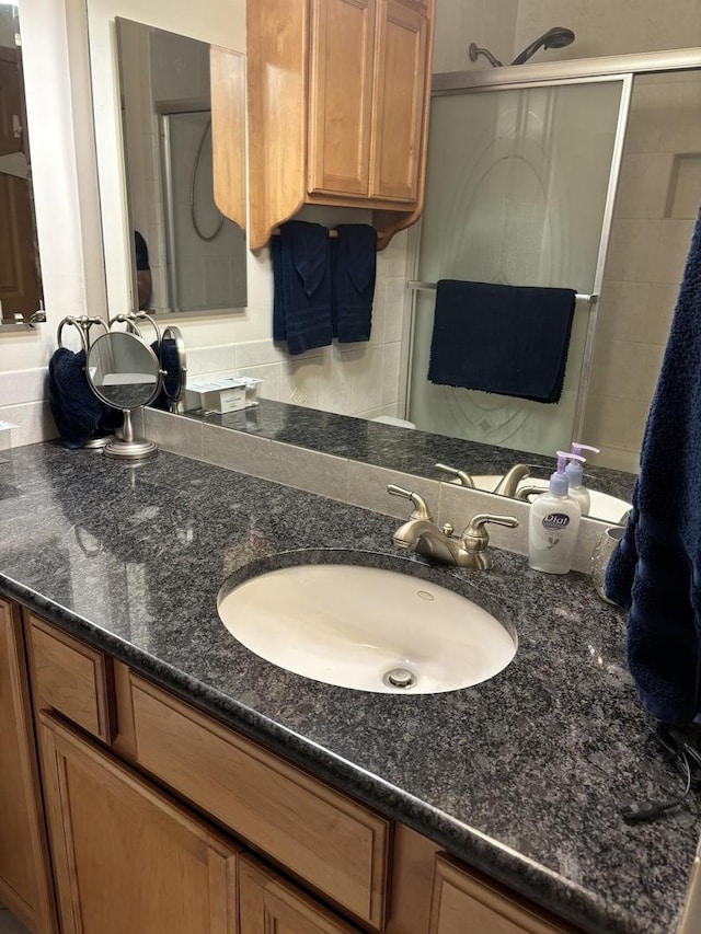 3991 Whispering Trails Dr, Hoffman Estates, IL 60192 - bathroom featuring a shower stall, vanity, and decorative backsplash