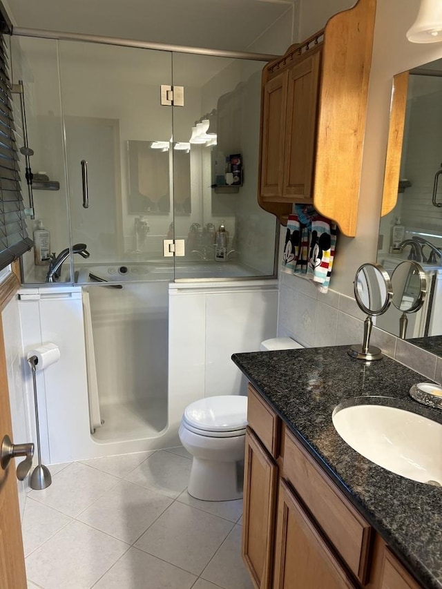 3991 Whispering Trails Dr, Hoffman Estates, IL 60192 - full bathroom with a shower stall, tile patterned floors, toilet, vanity, and washer / dryer