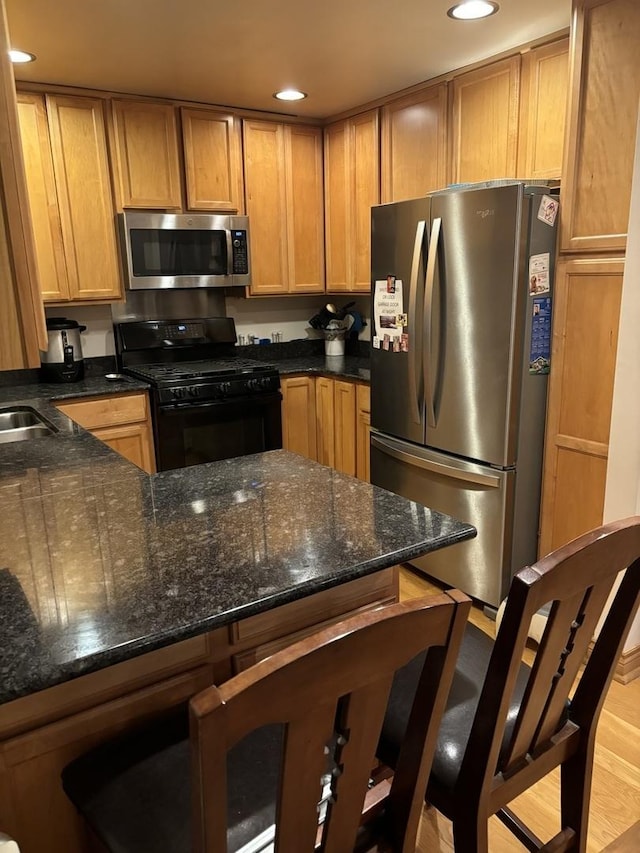 3991 Whispering Trails Dr, Hoffman Estates, IL 60192 - kitchen featuring stainless steel appliances, recessed lighting, dark stone counters, a peninsula, and a kitchen bar