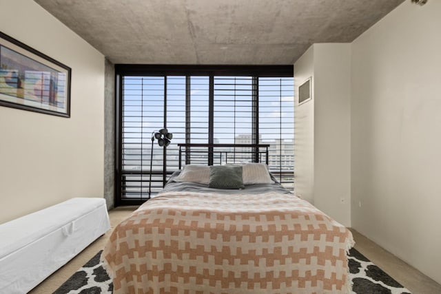 bedroom featuring carpet floors and multiple windows