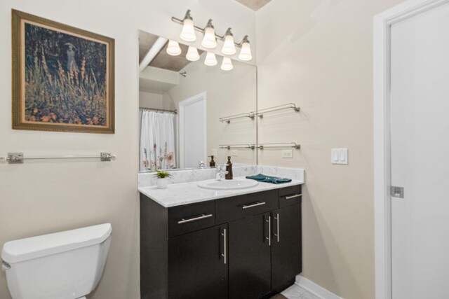 full bathroom featuring toilet, vanity, and baseboards