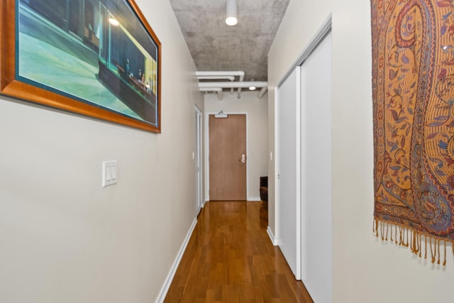 hall with wood finished floors and baseboards