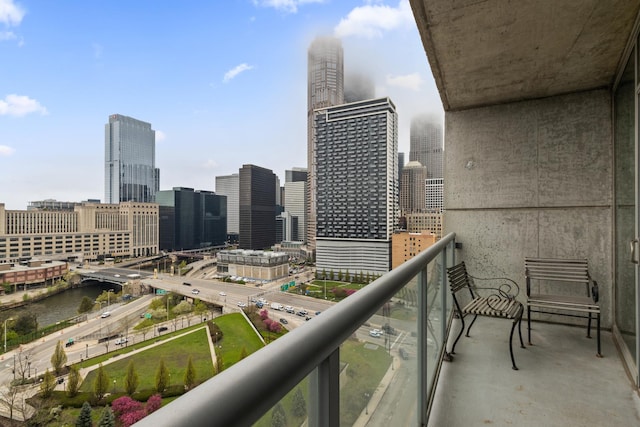 balcony with a view of skyline and a water view