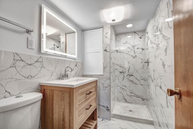 bathroom with a marble finish shower, toilet, vanity, tile walls, and marble finish floors