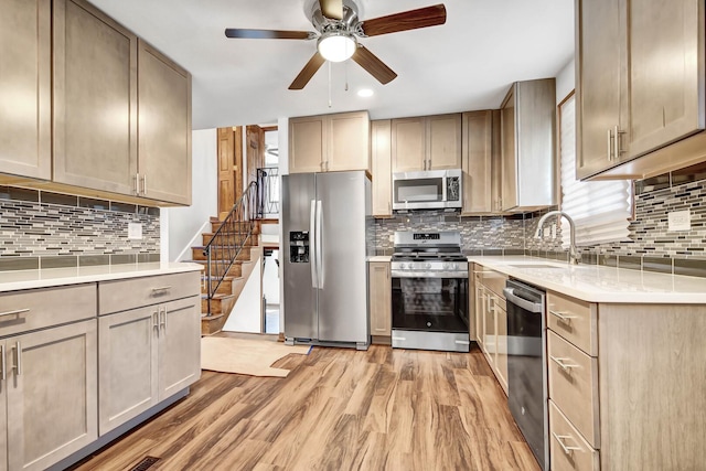kitchen with appliances with stainless steel finishes, a sink, backsplash, a ceiling fan, and recessed lighting
