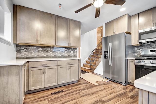 kitchen featuring appliances with stainless steel finishes, ceiling fan, light countertops, light wood-type flooring, and recessed lighting