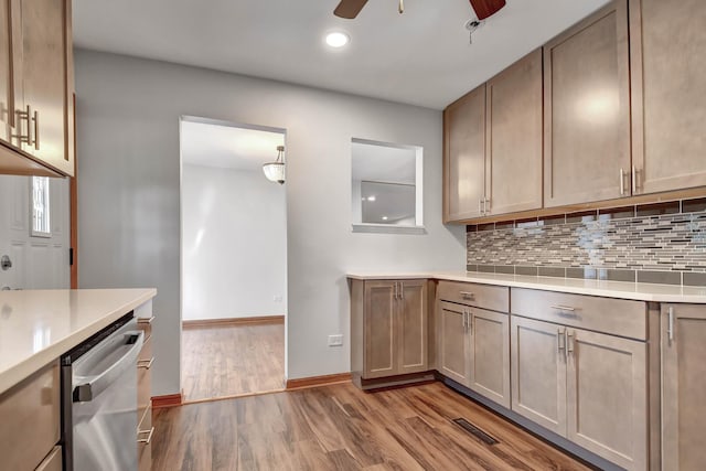 kitchen with dishwasher, a ceiling fan, light wood-style flooring, light countertops, and backsplash