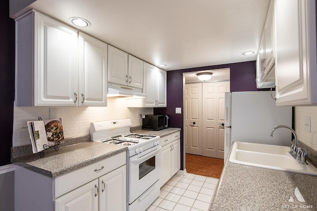 7930 Woodglen Ln Unit 204, Downers Grove, IL 60516 - kitchen with white appliances, under cabinet range hood, a sink, light tile patterned floors, and white cabinetry