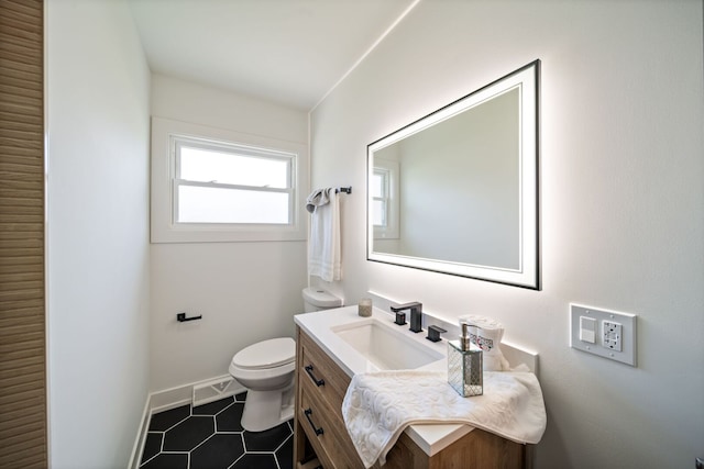 220 E Washington St, Des Plaines, IL 60016 - bathroom with toilet, baseboards, tile patterned floors, and vanity