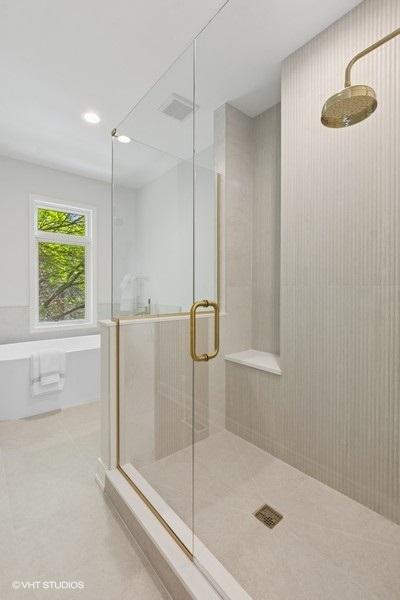 full bath featuring a shower stall, a freestanding bath, recessed lighting, and tile patterned flooring